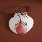 Pink scallop shell charm necklace tied in a bow