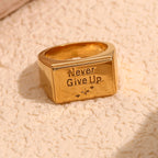 front view of rectangular Never Give Up signet ring