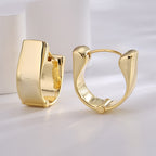 front and side views of gold plated brass huggie earrings