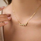 Clear stone cluster necklace worn at neckline