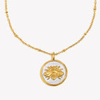 isolated front view of gold and silver bee pendant necklace