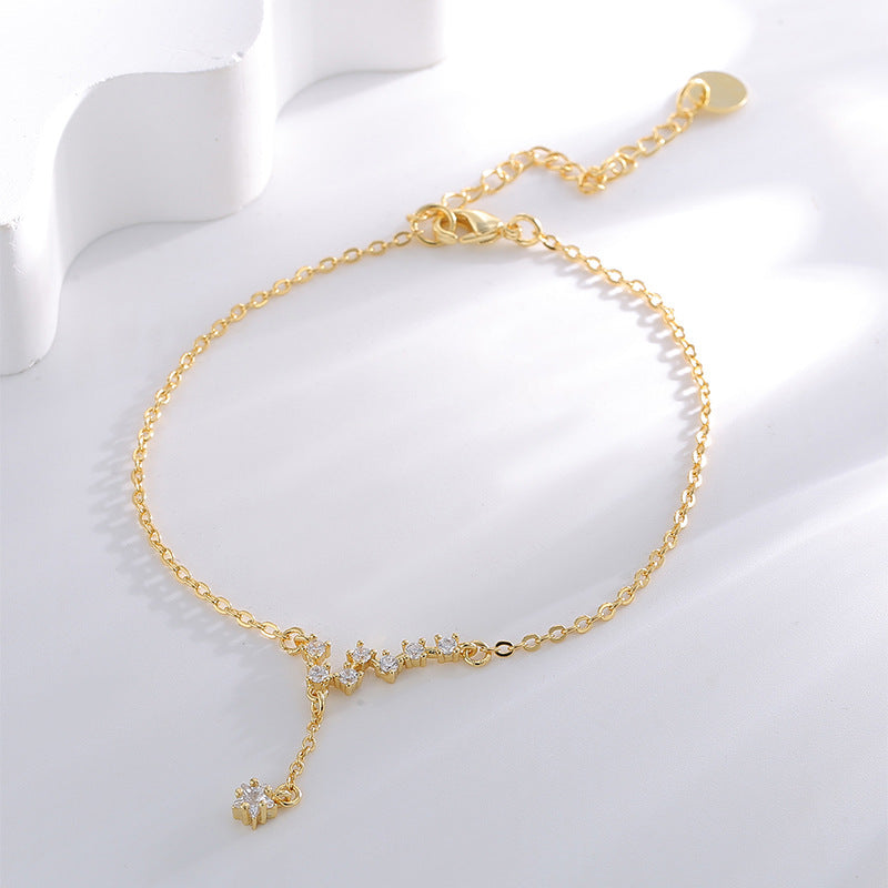 cubic zirconia constellation anklet arranged on a white display