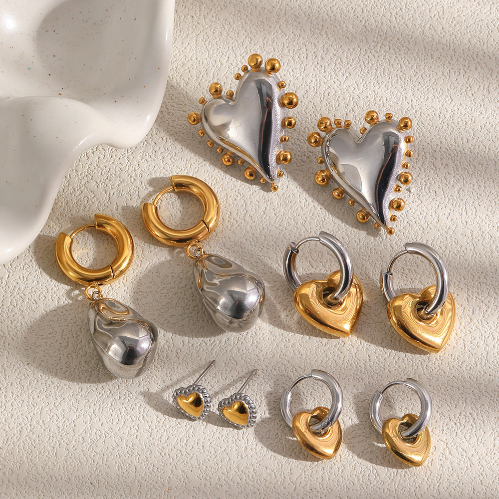 Heart earrings and irregular drop hoops arranged together
