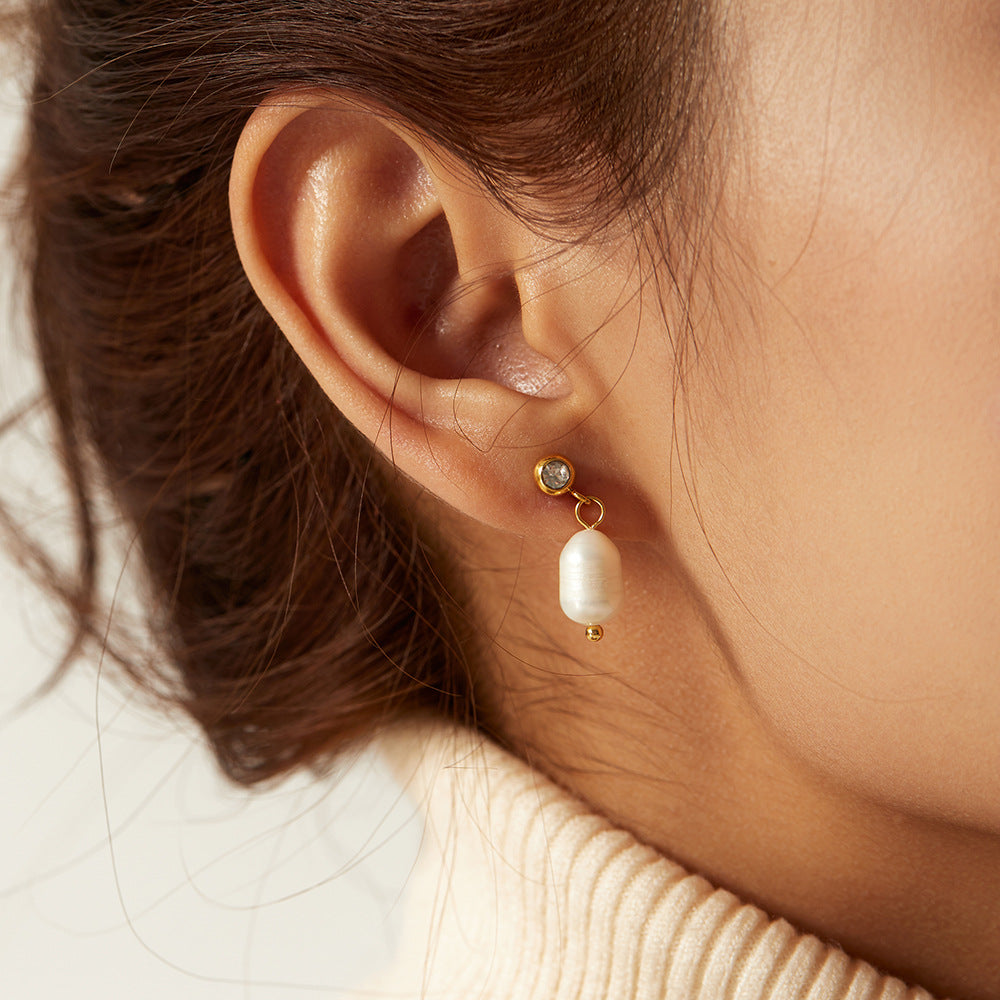 gold plated freshwater pearl drop earring worn from the side