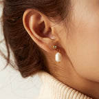 gold plated freshwater pearl drop earring worn from the side