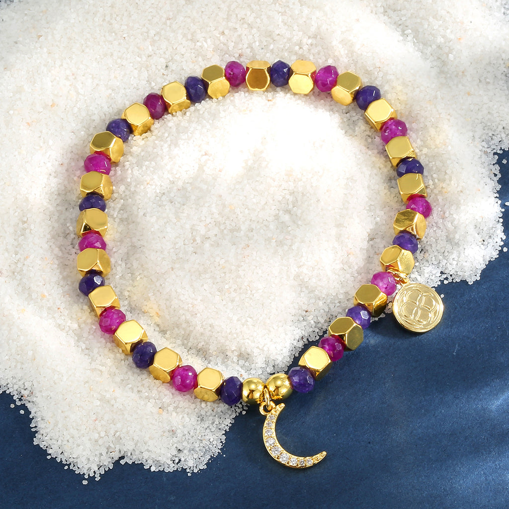 multicolor crescent moon bead bracelet on a blue display