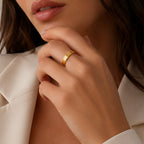 Slim gold-tone motif band worn on model