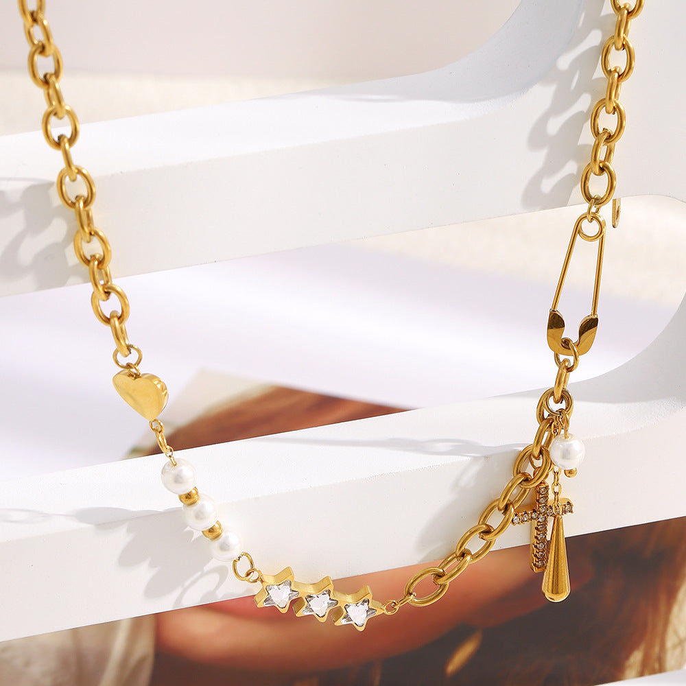 asymmetrical gold plated charm necklace on an iridescent display