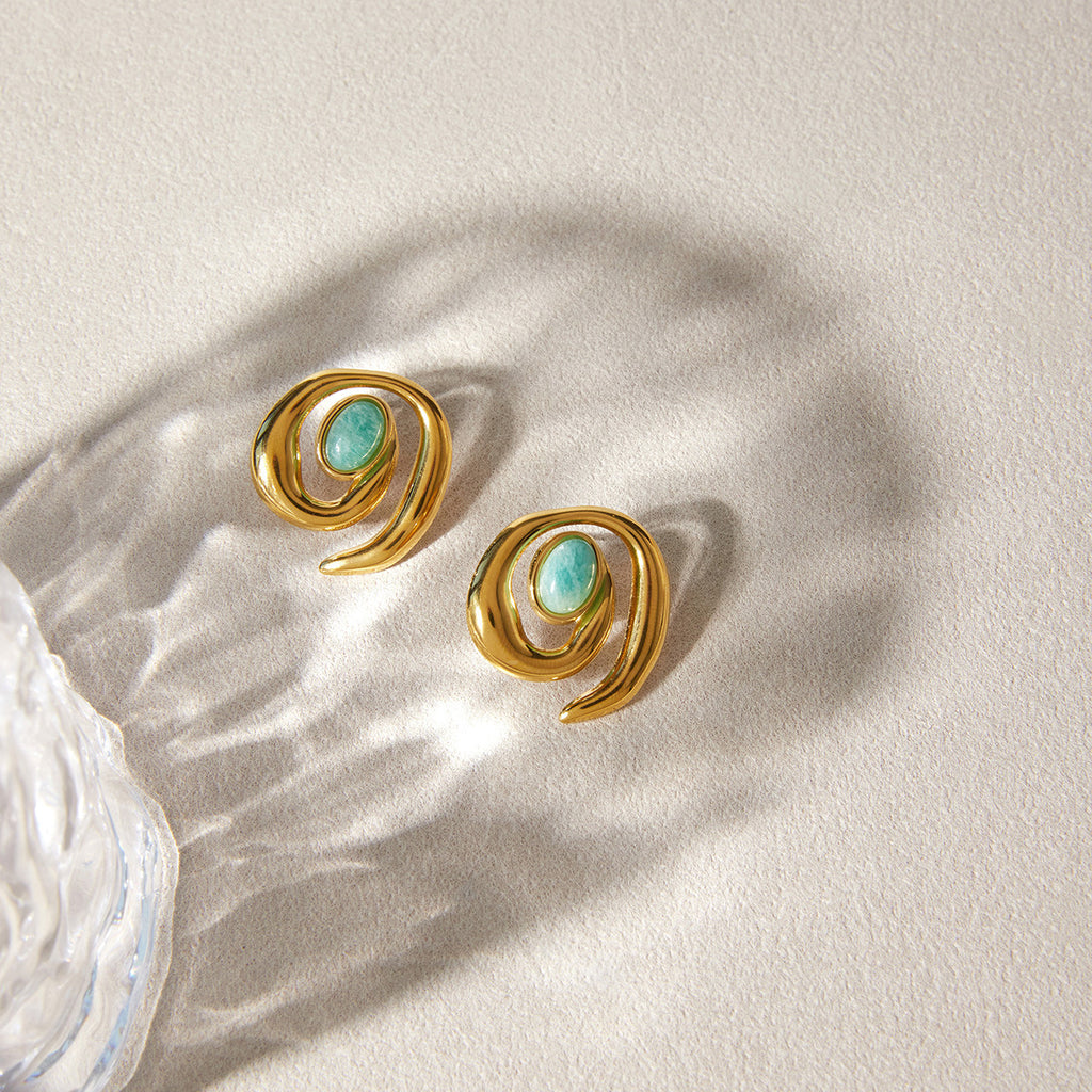 Gold-tone spiral stud earrings with green oval centers