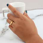 model wearing a gold plated starburst oval signet ring