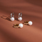 paired resin pearl huggie earrings in gold and silver finishes