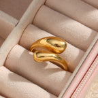 Gold-tone double teardrop ring in a jewelry case