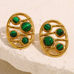 openwork oval malachite stud earrings styled on cream stone