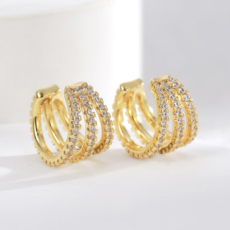 Gold plated open ear cuffs with three rows of clear stones on white blocks