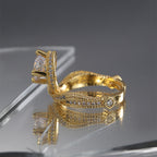 side profile of gold plated statement ring with four-prong basket