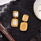Gold Tone Pearl-Look Stainless Steel Double Drop Earrings — paired earrings on a neutral surface