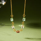 Pastel stone stainless steel necklace displayed against a green background