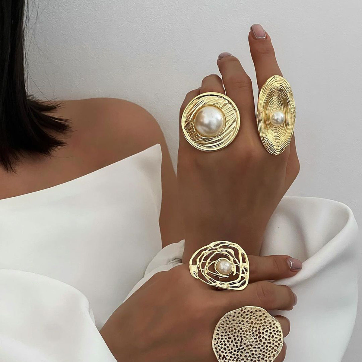 Textured oval pearl-look statement ring styled with other rings