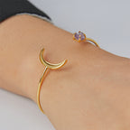 close wrist view of crescent cuff bracelet with purple stone
