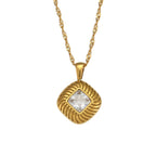 isolated gold plated square pendant necklace with a clear stone