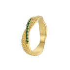 cutout of gold plated textured ring with curved green-stone row