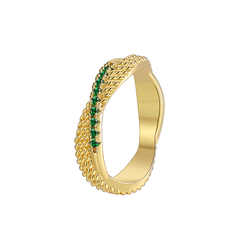 cutout of gold plated textured ring with curved green-stone row