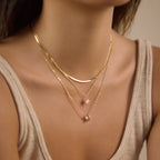 Layered celestial necklace shown on model from side