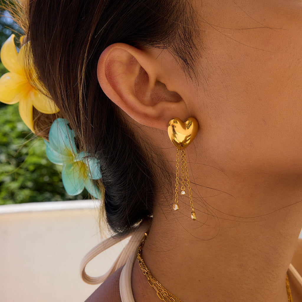 heart stud earrings with three graduated chain drops worn on ear