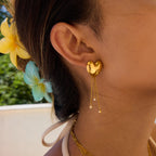 heart stud earrings with three graduated chain drops worn on ear