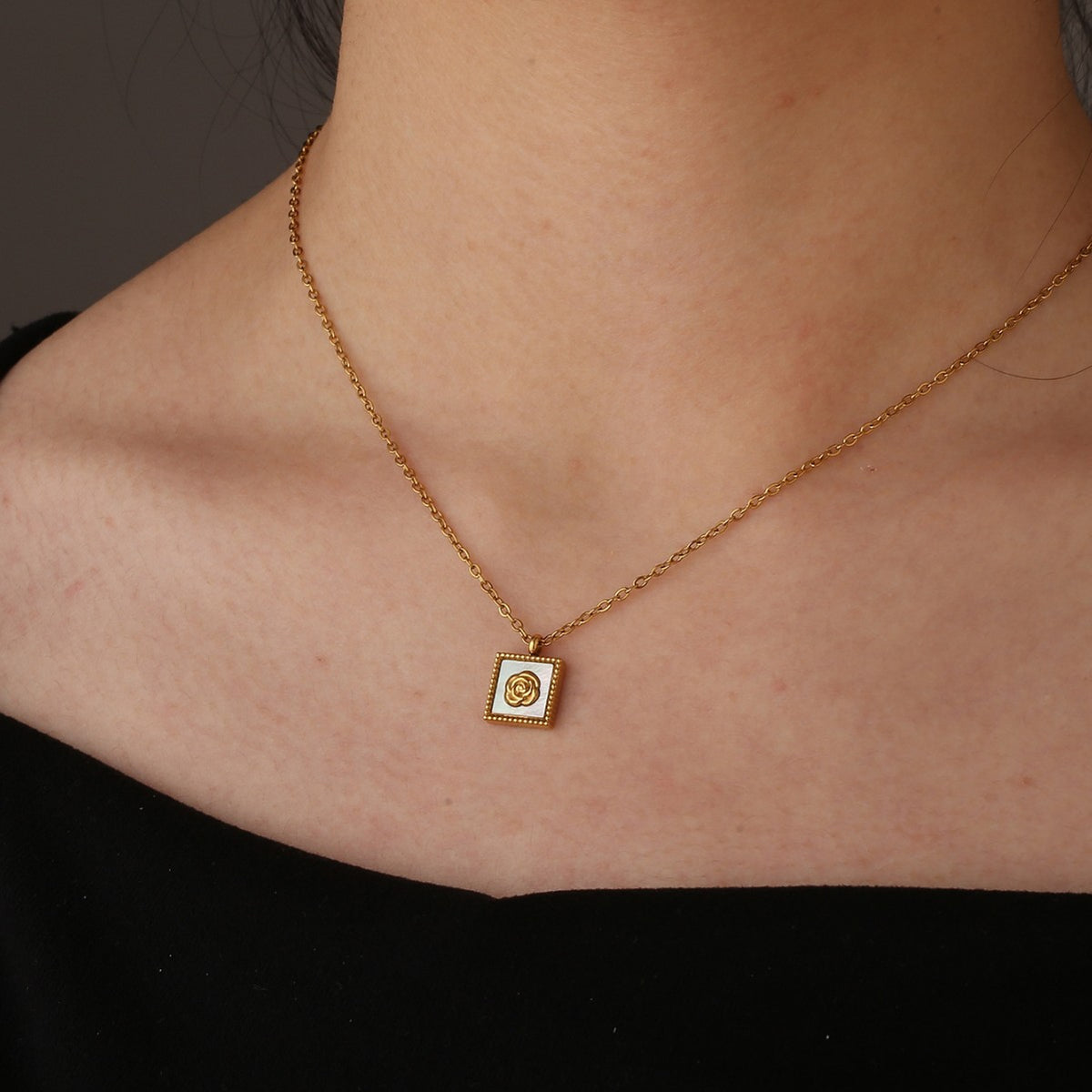 model wearing the compact square floral pendant necklace