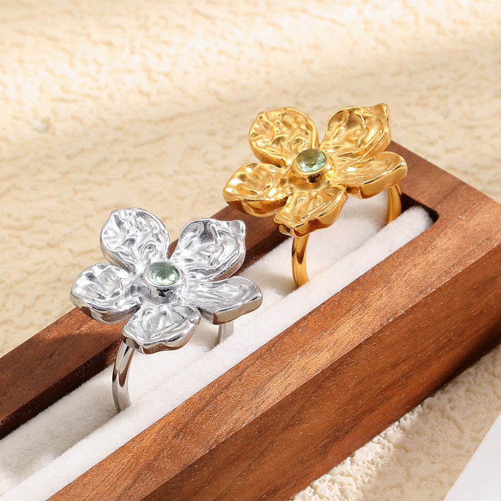 gold plated and silver-finish floral cocktail rings in a display box