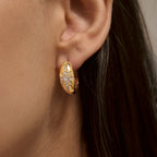 Starburst hoop earring shown on an ear