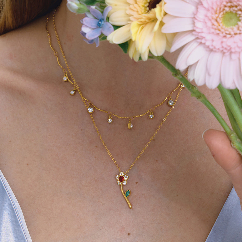 red rose necklace paired with a clear-stone station chain