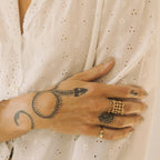 Wide woven ring styled with another ring