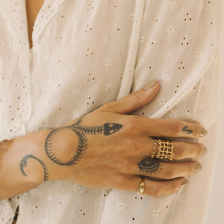 Wide woven ring styled with another ring