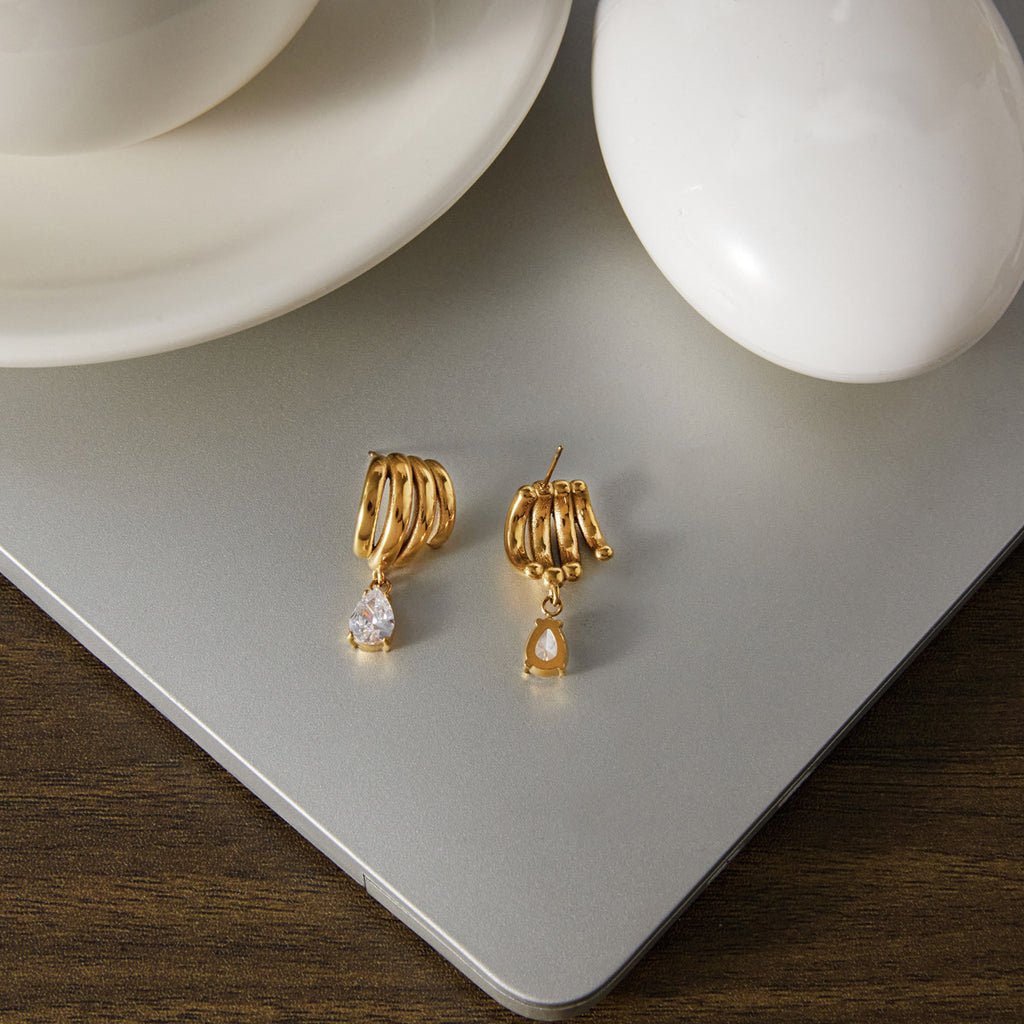Front and reverse of multi-loop drop earrings on a board