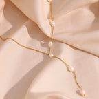 gold plated stainless steel Y necklace with five white freshwater pearls