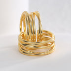 close-up of sculptural triple-band gold plated ear cuffs