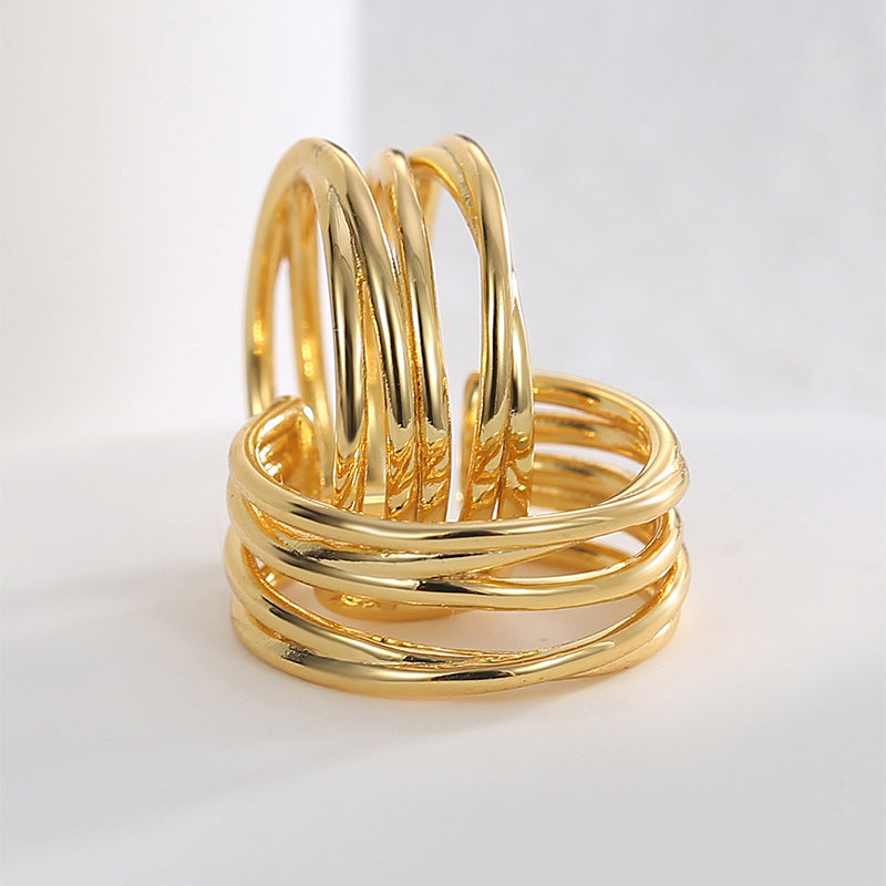 close-up of sculptural triple-band gold plated ear cuffs