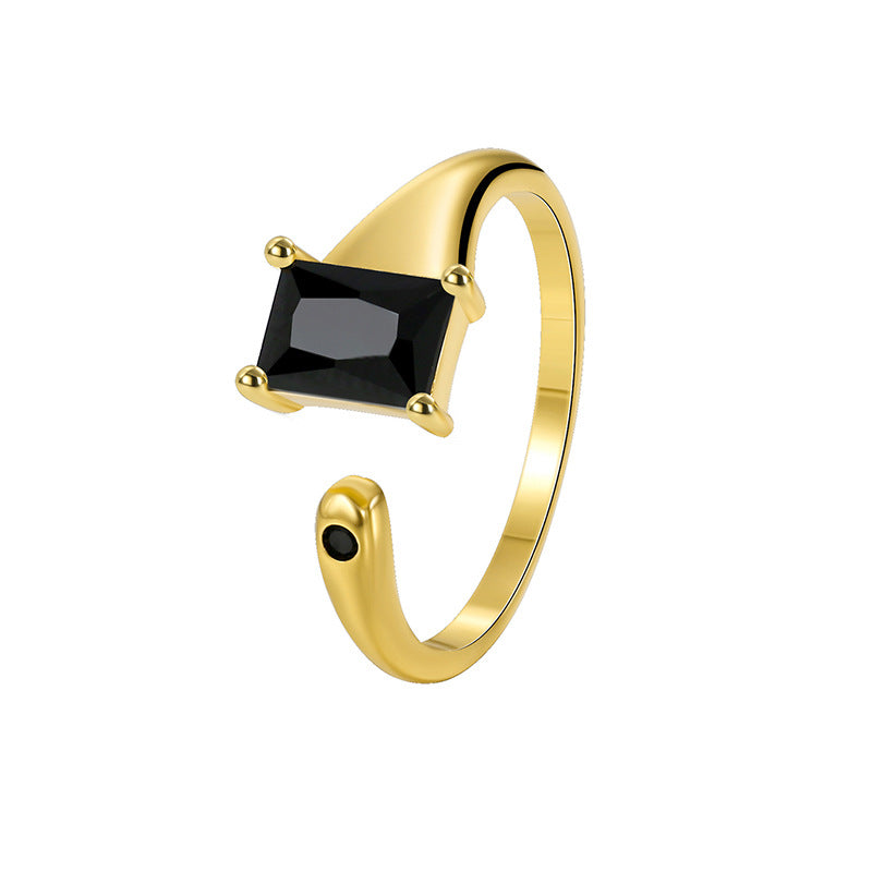 isolated gold plated rectangular black stone ring on white