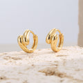 gold plated brass triple-lobe huggie hoop earrings on stone