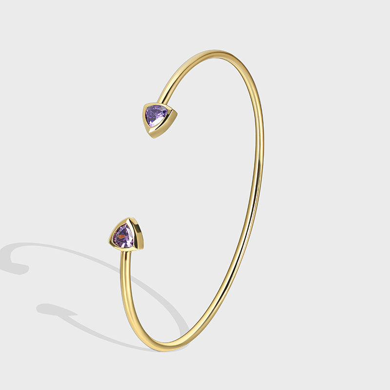 isolated gold plated open cuff with purple triangle stones