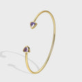 isolated gold plated open cuff with purple triangle stones
