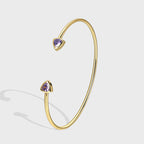 isolated gold plated open cuff with purple triangle stones