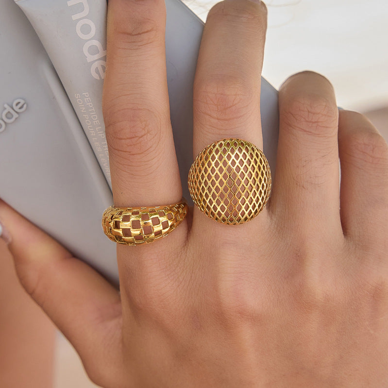 Checkerboard and diamond lattice rings worn on a hand