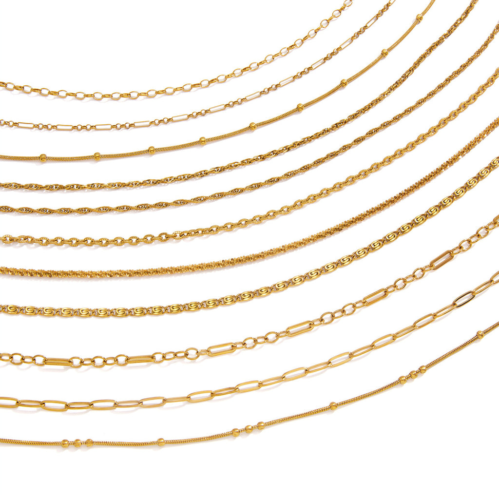 Gold tone chain necklace assortment on white