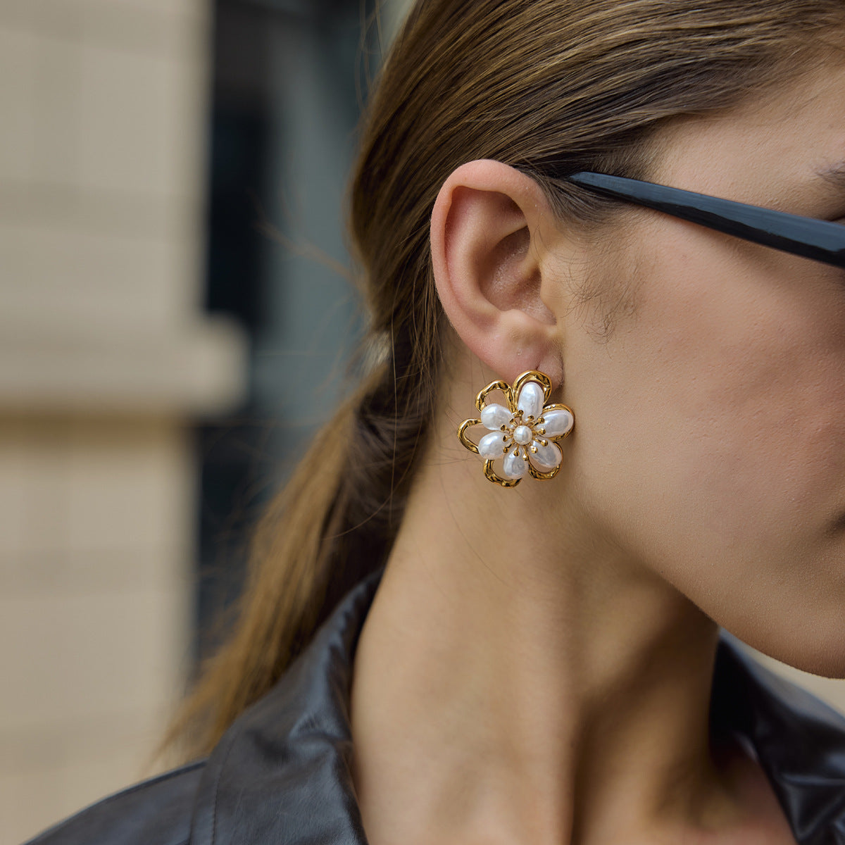 White pearl-look flower stud shown on the ear