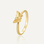 isolated gold plated ring with raised engraved butterfly
