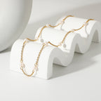 Freshwater pearl station necklace draped across a white stand