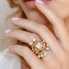 Hanging charm ring shown with other accent rings